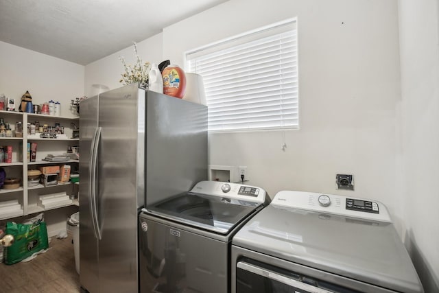 723 Slate Valley Ln, Spring, TX 77373 - clothes washing area with washing machine and dryer and wood finished floors