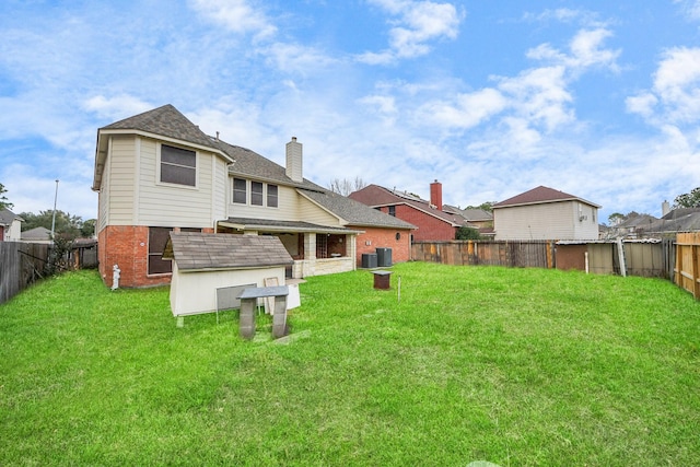 14731 Ravenscroft Way, Houston, TX 77083 - back of house with a chimney, brick siding, and a shingled roof