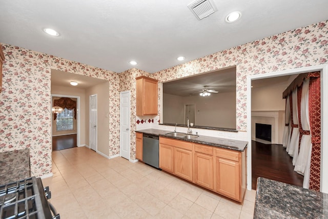 14731 Ravenscroft Way, Houston, TX 77083 - kitchen with wallpapered walls, a sink, dishwashing machine, baseboards, and light brown cabinetry
