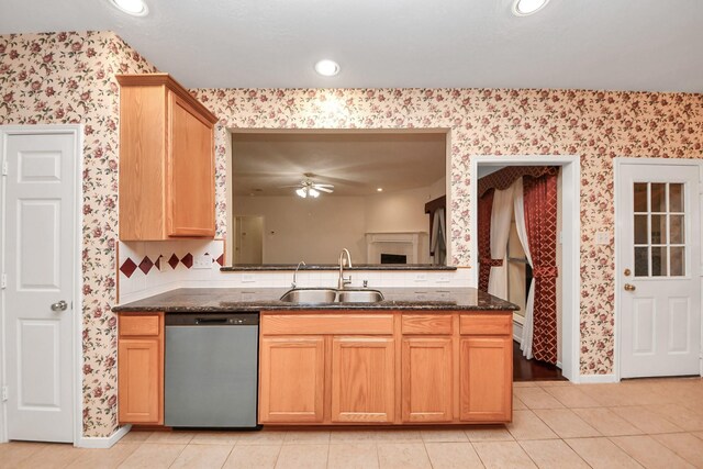 14731 Ravenscroft Way, Houston, TX 77083 - kitchen featuring dishwasher, wallpapered walls, a sink, a ceiling fan, and dark stone counters