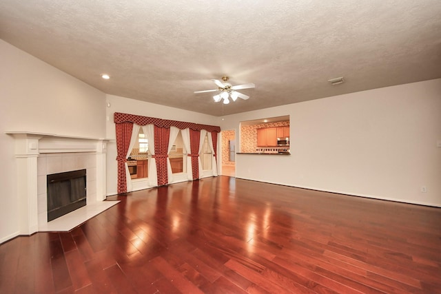 14731 Ravenscroft Way, Houston, TX 77083 - unfurnished living room featuring a ceiling fan, wood finished floors, recessed lighting, a textured ceiling, and a fireplace