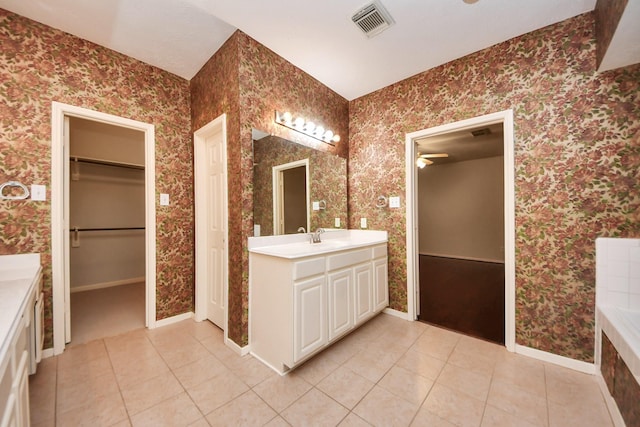 14731 Ravenscroft Way, Houston, TX 77083 - bathroom featuring tile patterned flooring, vanity, a spacious closet, and wallpapered walls