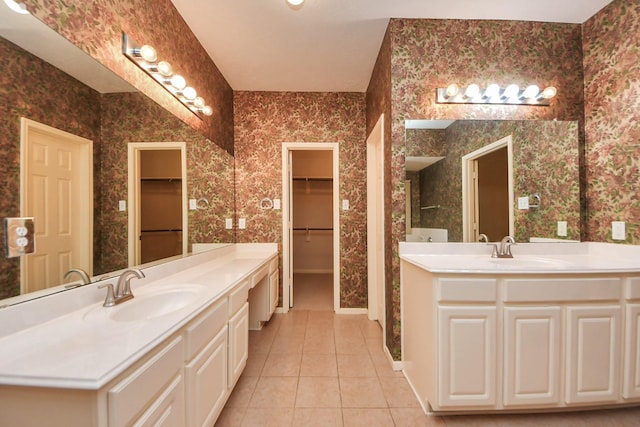 14731 Ravenscroft Way, Houston, TX 77083 - full bath with wallpapered walls, tile patterned floors, two vanities, and a walk in closet