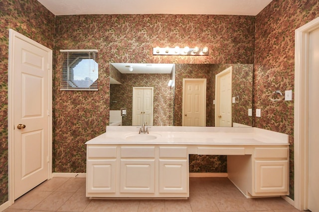14731 Ravenscroft Way, Houston, TX 77083 - bathroom with tile patterned floors, wallpapered walls, vanity, and baseboards