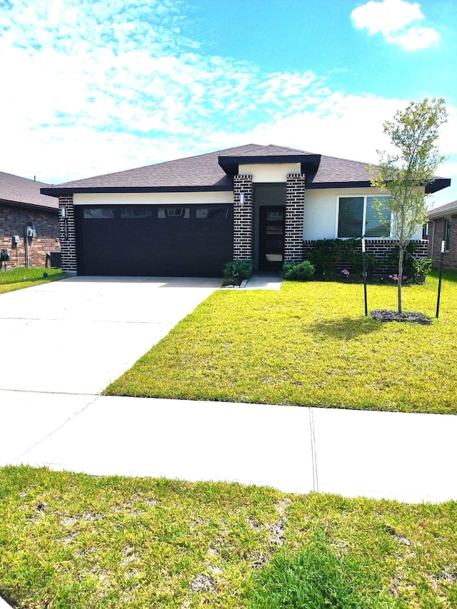 19027 Drayton Village Trce, Richmond, TX 77407 - prairie-style home featuring an attached garage, stucco siding, concrete driveway, and a front lawn
