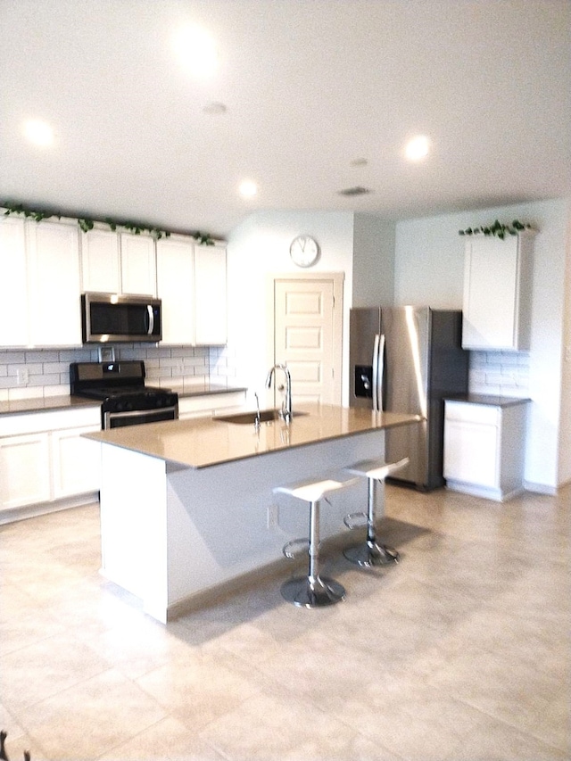 19027 Drayton Village Trce, Richmond, TX 77407 - kitchen with appliances with stainless steel finishes, a sink, decorative backsplash, recessed lighting, and white cabinetry