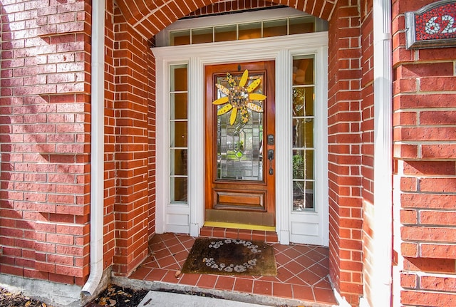 doorway to property with brick siding