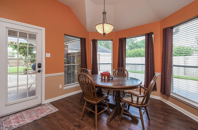 dining area with vaulted ceiling, dark wood-type flooring, and baseboards