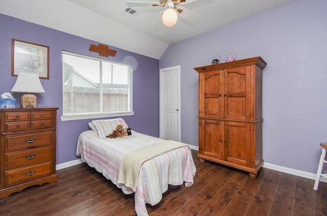 bedroom featuring dark wood finished floors, vaulted ceiling, baseboards, and a ceiling fan