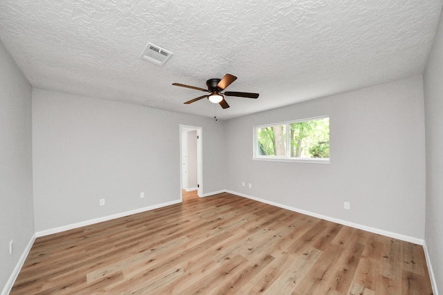 1914 Round Wind Trl, Crosby, TX 77532 - spare room with wood finished floors, a ceiling fan, baseboards, and a textured ceiling