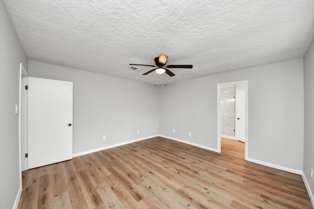 1914 Round Wind Trl, Crosby, TX 77532 - empty room with light wood-style flooring, a ceiling fan, baseboards, and a textured ceiling