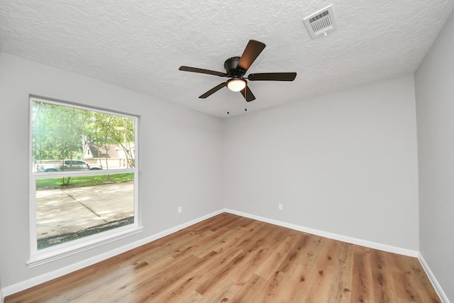 1914 Round Wind Trl, Crosby, TX 77532 - spare room with light wood finished floors, a textured ceiling, baseboards, and a ceiling fan