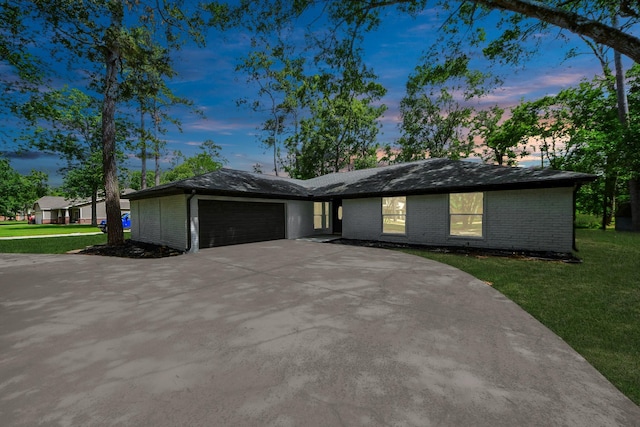 1914 Round Wind Trl, Crosby, TX 77532 - view of front facade with an attached garage, brick siding, a front yard, and driveway