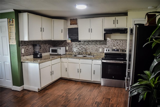 275 Georgia St, Houston, TX 77029 - kitchen featuring stainless steel appliances, a sink, under cabinet range hood, dark wood-style floors, and white cabinets