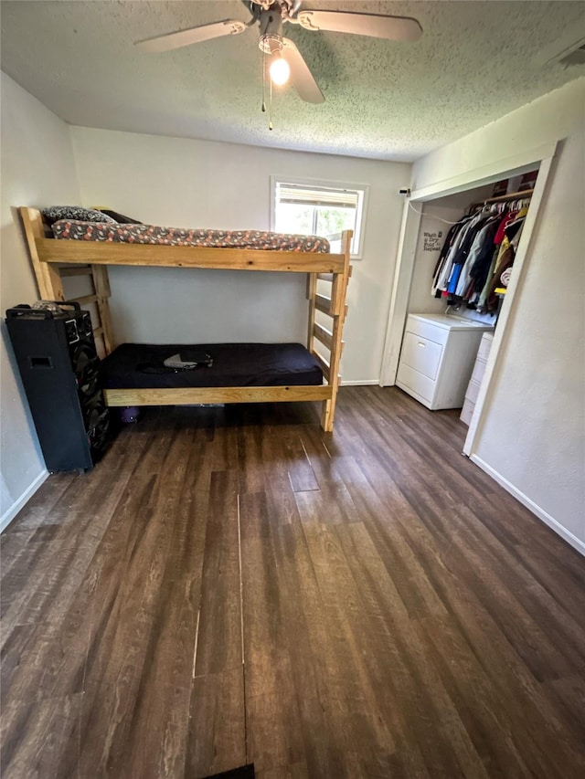 275 Georgia St, Houston, TX 77029 - bedroom featuring a textured ceiling, wood finished floors, washer / clothes dryer, baseboards, and ceiling fan