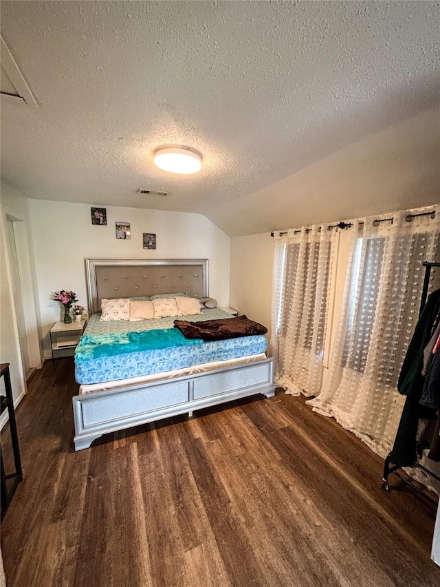 275 Georgia St, Houston, TX 77029 - bedroom featuring wood finished floors, a textured ceiling, and lofted ceiling