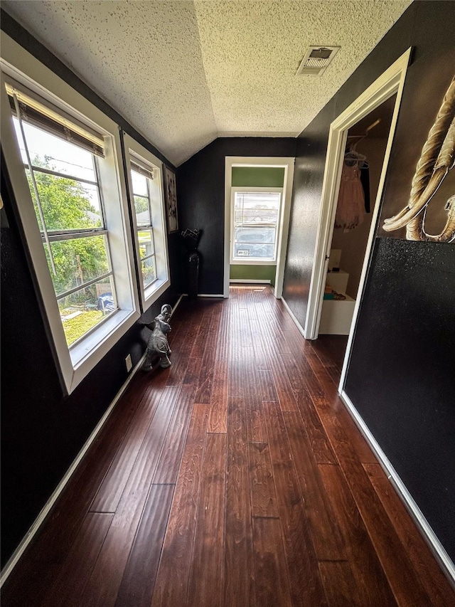 275 Georgia St, Houston, TX 77029 - hallway with lofted ceiling, wood-type flooring, a textured ceiling, and baseboards
