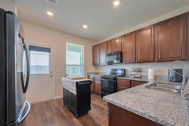 14502 Myrtle Hill Dr, Houston, TX 77069 - kitchen featuring black appliances, a sink, dark wood-type flooring, recessed lighting, and light stone counters