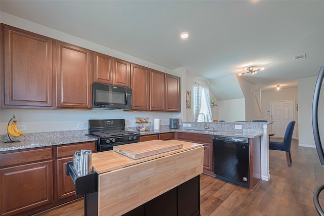 14502 Myrtle Hill Dr, Houston, TX 77069 - kitchen featuring black appliances, a sink, a peninsula, butcher block counters, and vaulted ceiling