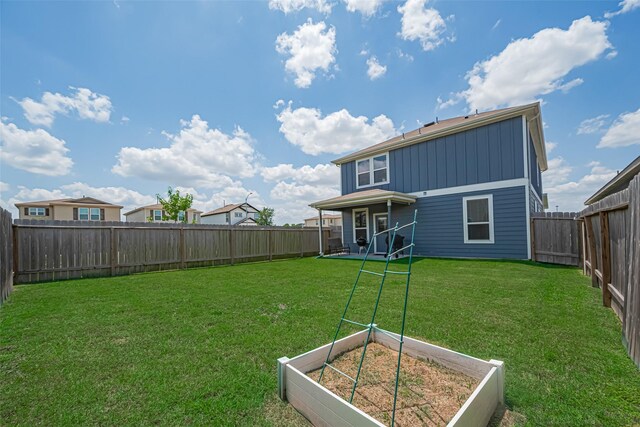 14502 Myrtle Hill Dr, Houston, TX 77069 - rear view of house with a vegetable garden and board and batten siding