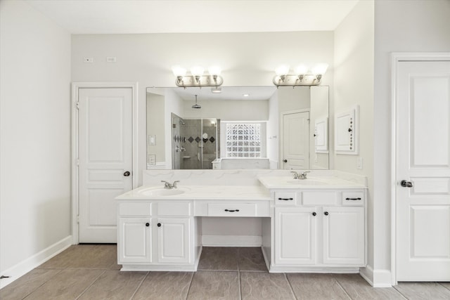 full bathroom featuring tiled shower, double vanity, and baseboards