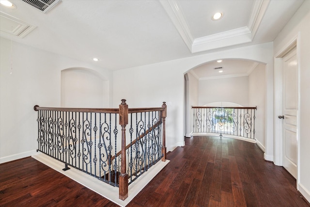 corridor featuring wood-type flooring, crown molding, recessed lighting, baseboards, and attic access