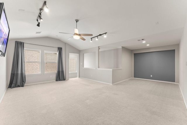 1830 Britton Key Ln, Spring, TX 77386 - empty room featuring rail lighting, a ceiling fan, light carpet, lofted ceiling, and baseboards