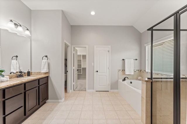 1830 Britton Key Ln, Spring, TX 77386 - full bathroom featuring a bath, vanity, tile patterned flooring, lofted ceiling, and baseboards