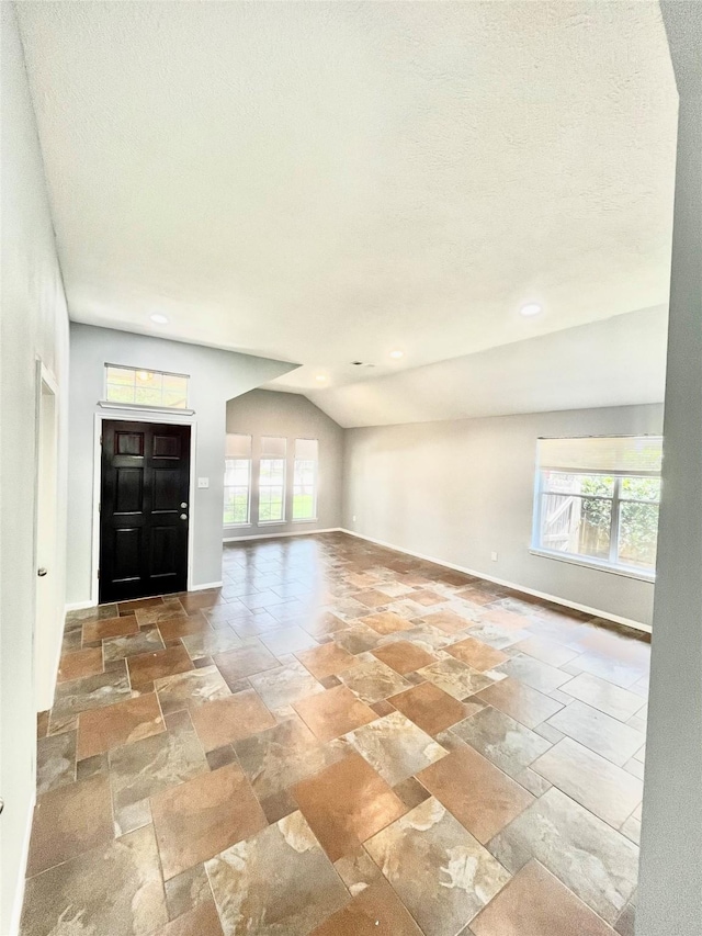 3209 Crimson Coast Dr, League City, TX 77573 - entrance foyer featuring baseboards, stone tile floors, and vaulted ceiling