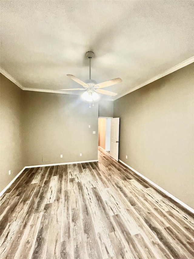 3209 Crimson Coast Dr, League City, TX 77573 - unfurnished room featuring ornamental molding, wood finished floors, a ceiling fan, baseboards, and a textured ceiling