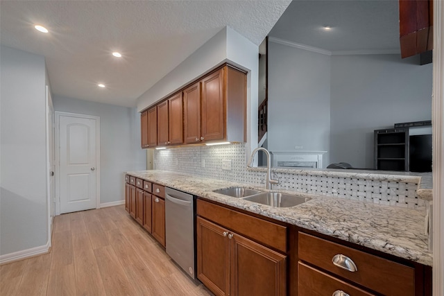 64 Hideaway Dr, Friendswood, TX 77546 - kitchen with a sink, dishwasher, baseboards, light wood-style floors, and brown cabinets