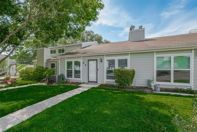 64 Hideaway Dr, Friendswood, TX 77546 - view of front facade featuring a front yard, cooling unit, and a chimney
