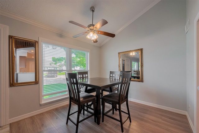 64 Hideaway Dr, Friendswood, TX 77546 - dining space featuring ornamental molding, vaulted ceiling, wood finished floors, baseboards, and a ceiling fan