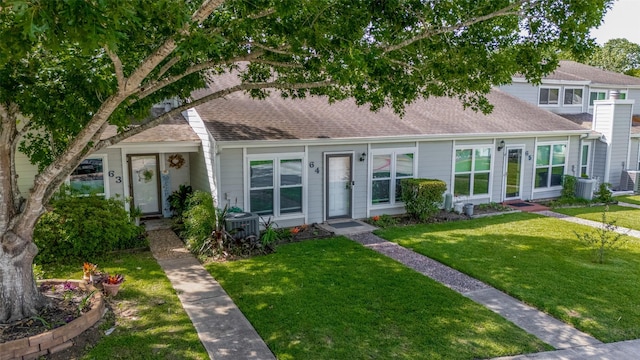 64 Hideaway Dr, Friendswood, TX 77546 - view of front of home with roof with shingles, a front yard, and central air condition unit