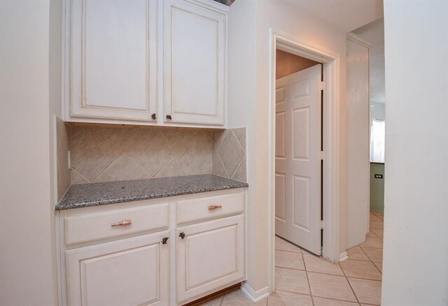 16535 Ruby Meadow Dr, Houston, TX 77095 - kitchen with light tile patterned floors, stone counters, and decorative backsplash