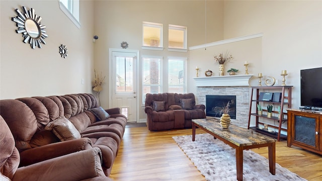 1911 Thunder Ridge Way, Houston, TX 77089 - living area featuring a high ceiling, a fireplace, plenty of natural light, and light wood finished floors