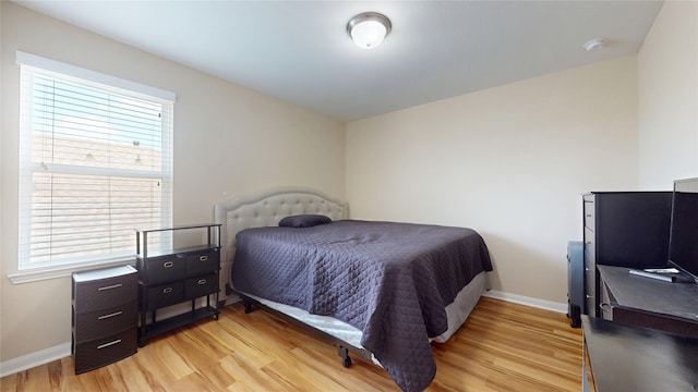1911 Thunder Ridge Way, Houston, TX 77089 - bedroom featuring light wood finished floors, baseboards, and multiple windows