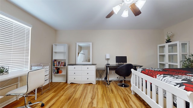 1911 Thunder Ridge Way, Houston, TX 77089 - bedroom featuring a desk, multiple windows, and light wood-style flooring