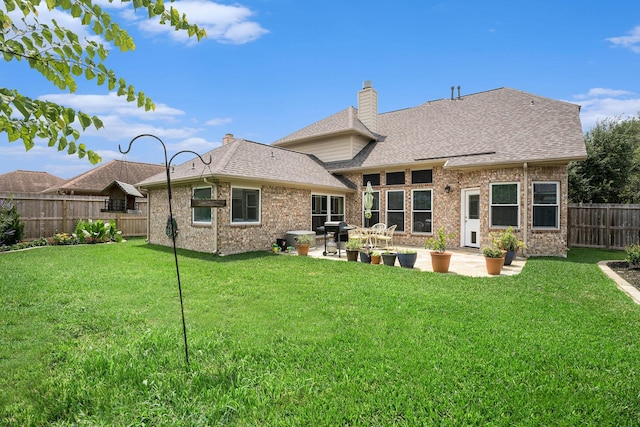 2385 Golden Shores Ln, League City, TX 77573 - rear view of property with a patio area, a chimney, brick siding, and a shingled roof