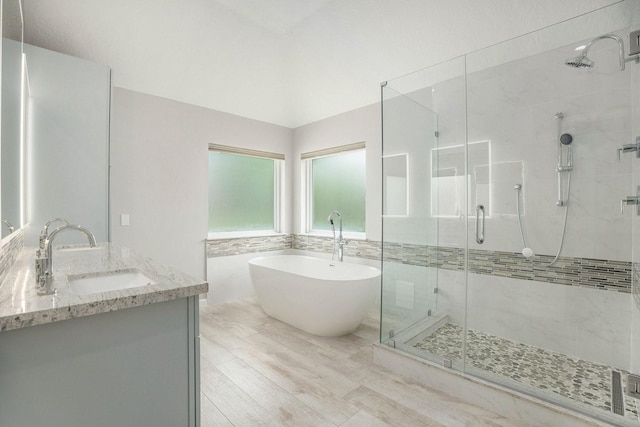 2385 Golden Shores Ln, League City, TX 77573 - bathroom featuring a shower stall, a freestanding tub, vanity, and wood finished floors