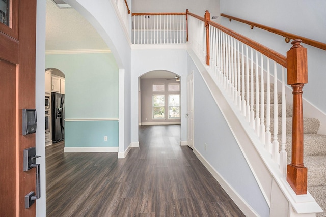 2385 Golden Shores Ln, League City, TX 77573 - entryway with dark wood-type flooring, a ceiling fan, baseboards, stairs, and crown molding