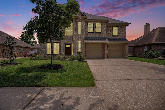 2385 Golden Shores Ln, League City, TX 77573 - traditional-style home with driveway, a garage, a lawn, and brick siding