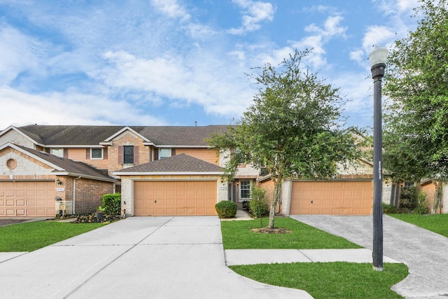 14922 Havenvale Ln, Houston, TX 77049 - view of front of home with concrete driveway, a front yard, brick siding, and a shingled roof