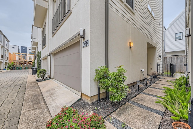 407 N Nagle St Unit E, Houston, TX 77003 - view of side of property with fence and stucco siding