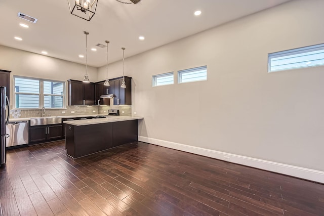 407 N Nagle St Unit E, Houston, TX 77003 - kitchen with a sink, appliances with stainless steel finishes, a peninsula, plenty of natural light, and recessed lighting