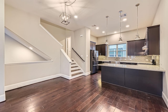 407 N Nagle St Unit E, Houston, TX 77003 - kitchen with stainless steel fridge with ice dispenser, light countertops, dark brown cabinets, dark wood-style flooring, and tasteful backsplash