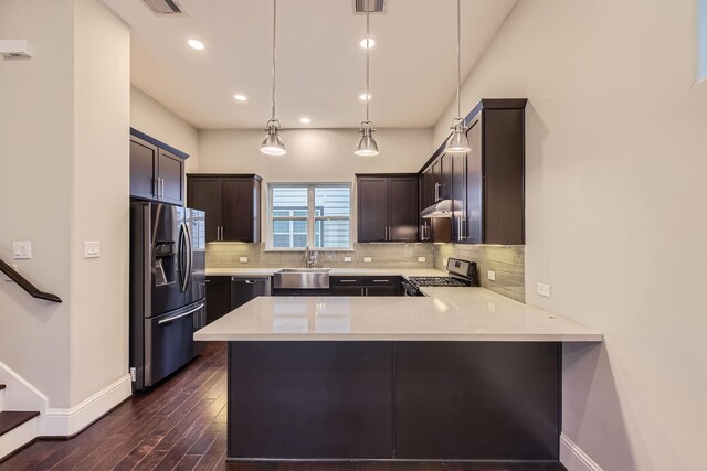 407 N Nagle St Unit E, Houston, TX 77003 - kitchen with appliances with stainless steel finishes, a sink, baseboards, light countertops, and dark brown cabinets