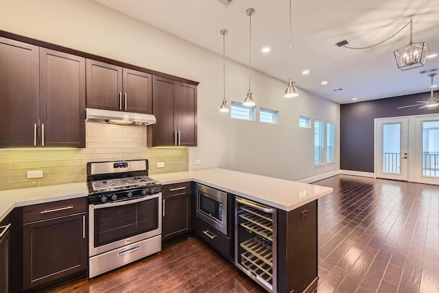 407 N Nagle St Unit E, Houston, TX 77003 - kitchen featuring appliances with stainless steel finishes, under cabinet range hood, beverage cooler, light countertops, and dark brown cabinets