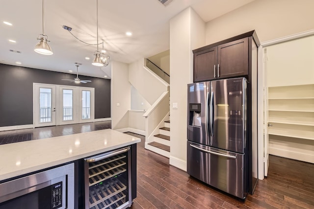 407 N Nagle St Unit E, Houston, TX 77003 - kitchen with appliances with stainless steel finishes, beverage cooler, dark wood-style flooring, dark brown cabinetry, and light stone counters