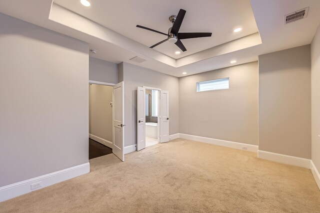 407 N Nagle St Unit E, Houston, TX 77003 - unfurnished bedroom featuring carpet, recessed lighting, a tray ceiling, baseboards, and ensuite bath